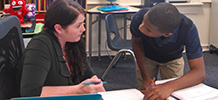 TTA teacher and student working together in classroom