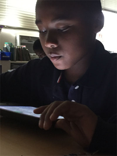Student using a tablet in class at Titusville Academy